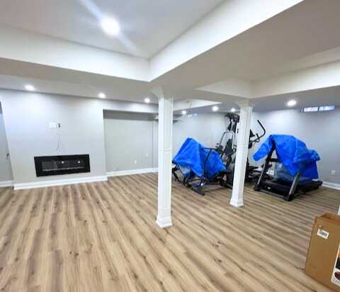 Grey vinyl flooring with built in tv wall, wet bar,
