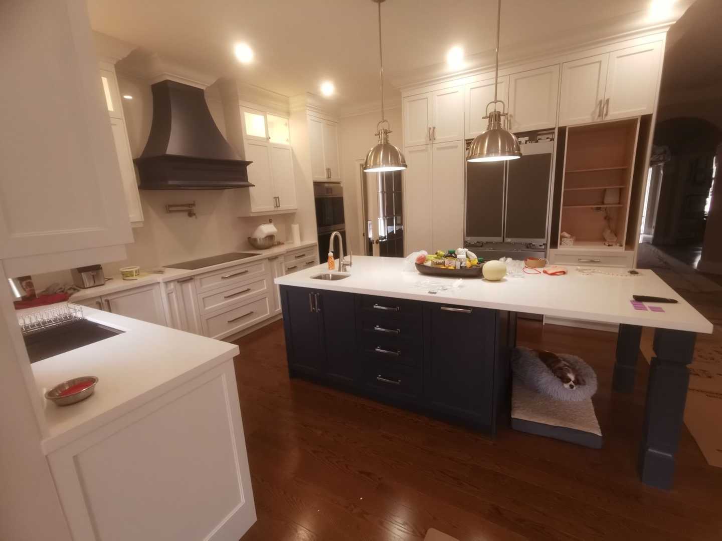 Complete home renovation with a statement wavy-textured fireplace wall. Kitchen
